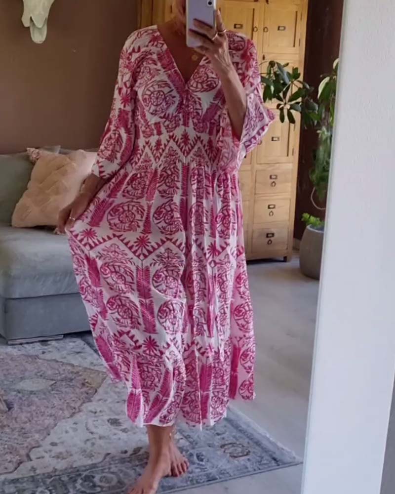 Elegant tryckt klänning med V-ringad veck och bell-sleeve