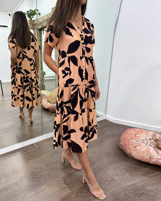 Klänning med fickor och slag och tryck