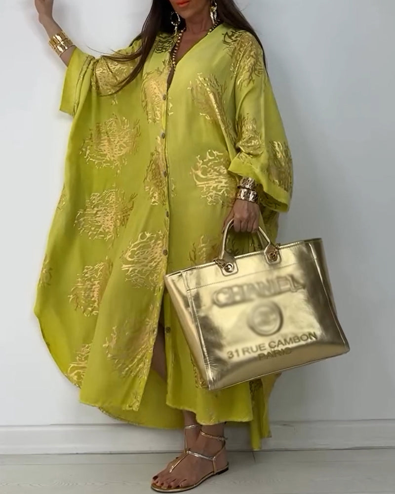 Långärmad lös klänning med tryck med knappar