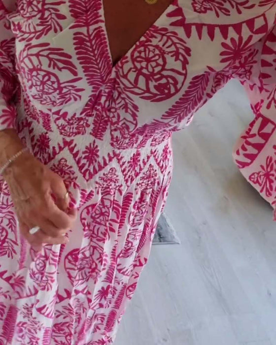 Elegant tryckt klänning med V-ringad veck och bell-sleeve