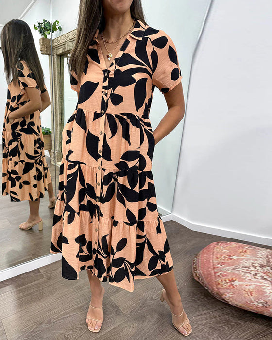 Klänning med fickor och slag och tryck