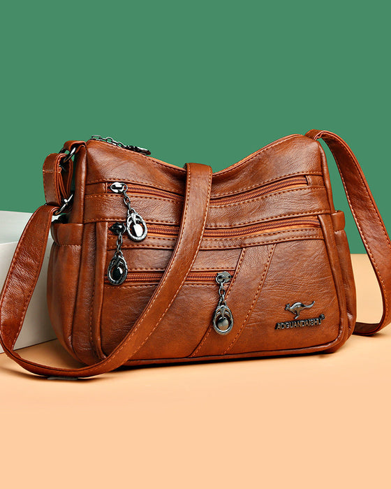 Korsväska i mjukt läder med flera fickor