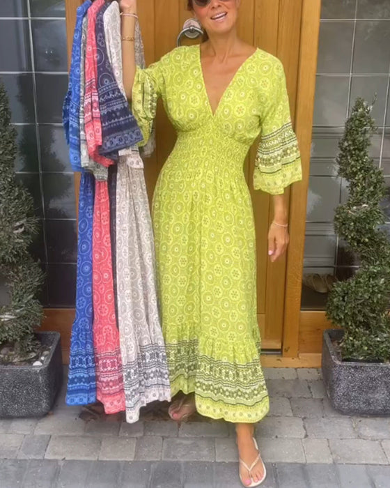 Lång klänning med djup V-ringning och utsvängd ärm