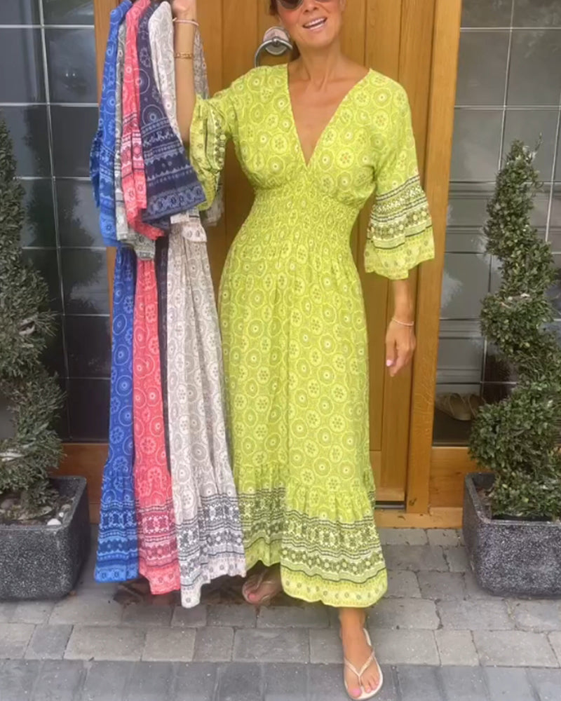 Lång klänning med djup V-ringning och utsvängd ärm