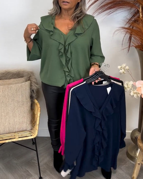 Ensfarget elegant topp med volang