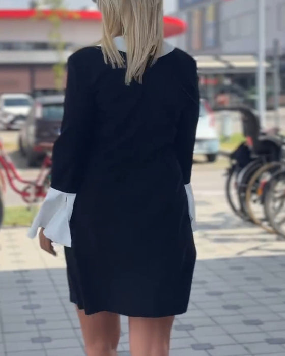 Elegant klänning med klockärm i kontrast