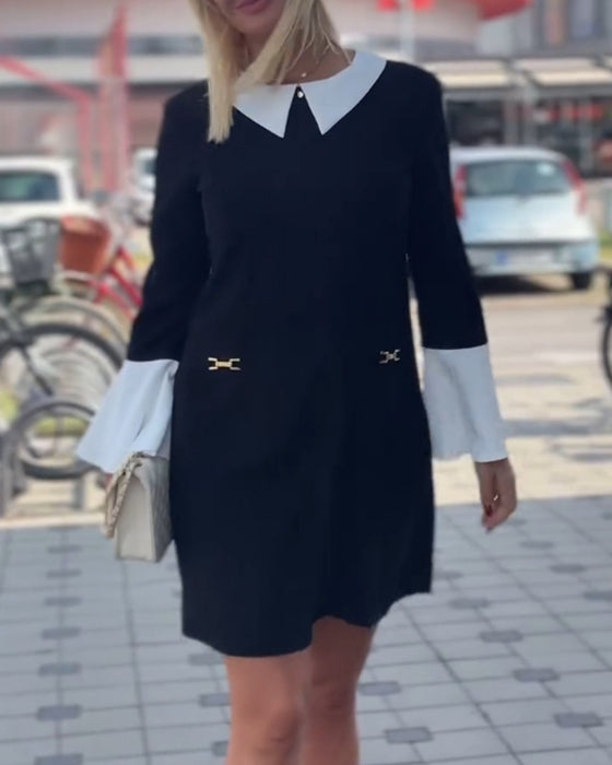 Elegant klänning med klockärm i kontrast
